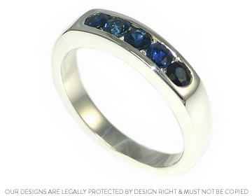 Unique white gold eternity ring with channel set blue sapphires