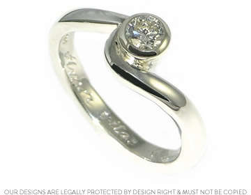 Beautifully sparkly diamond held in a twist engagement ring