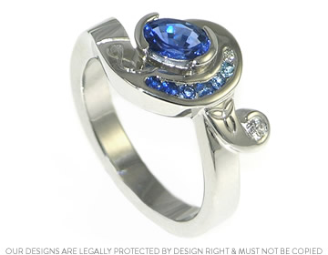 Gwen's twist style engagement ring with an oval cut blue sapphire