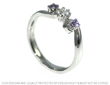 David wanted a trilogy style engagement ring with purple stones