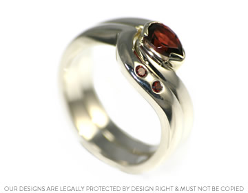 Katie's white gold wave style fitted wedding ring with beautiful garnets