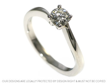 A unique platinum and diamond solitaire twist engagement ring