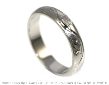 Platinum wedding ring with vine leaf engraving and contrasting finishes