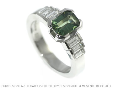 A Platinum engagement ring with a central green sapphire