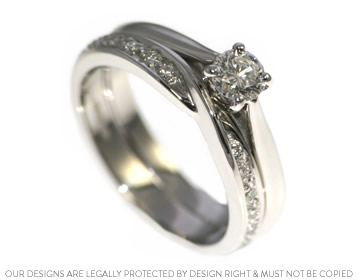 Twist style wedding ring with striking diamond shoulders