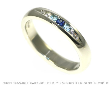 Candy's beautiful channel set wedding ring with blue stones