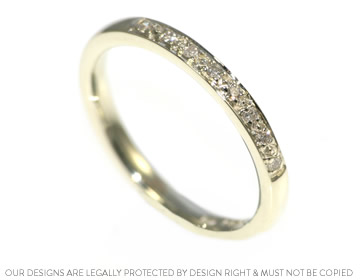 Handcrafted white gold wedding ring with pave set diamonds