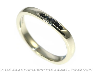 Nicola's sparkling wedding ring with crisp dark sapphires