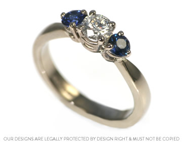 A classic diamond and sapphire trilogy engagement ring