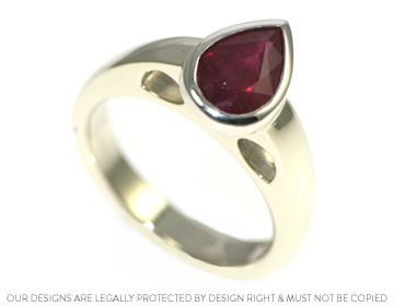 A dramatic white gold and striking red ruby dress ring