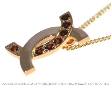 Anne's beautiful 22ct yellow gold and ruby embracing pendant