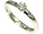 a bespoke handmade 9ct white gold, diamond and topaz engagement ring