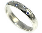 a bespoke sterling silver and blue sapphire eternity ring