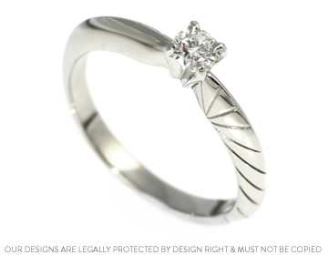 Delicate platinum engagement ring with engraved detail