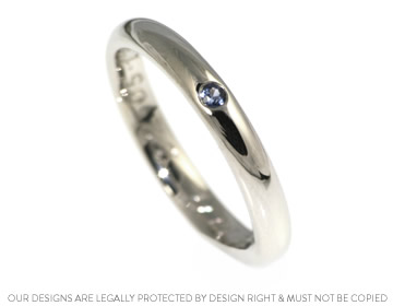 A bespoke 9ct white gold and sapphire eternity ring