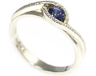 jo's twist style engagement ring with a blue sapphire