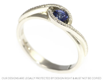 Jo's twist style engagement ring with a blue sapphire