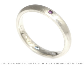 A bespoke white gold wedding ring with gemstones