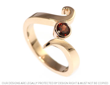 A bespoke rose gold and red garnet dress ring