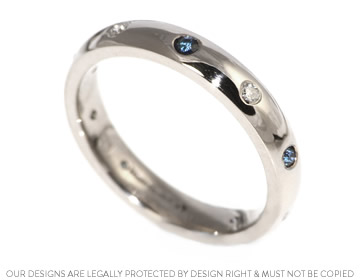 A bespoke white gold eternity ring with sapphires and diamonds