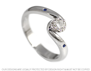 A timeless palladium, diamond and sapphire twist engagement ring 