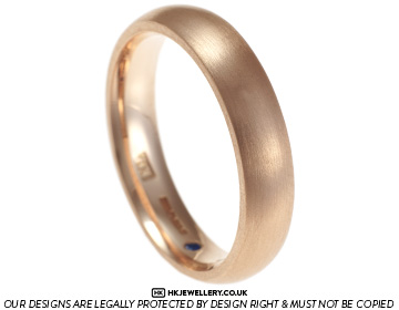 Bryan's rose gold wedding ring with a hidden blue sapphire