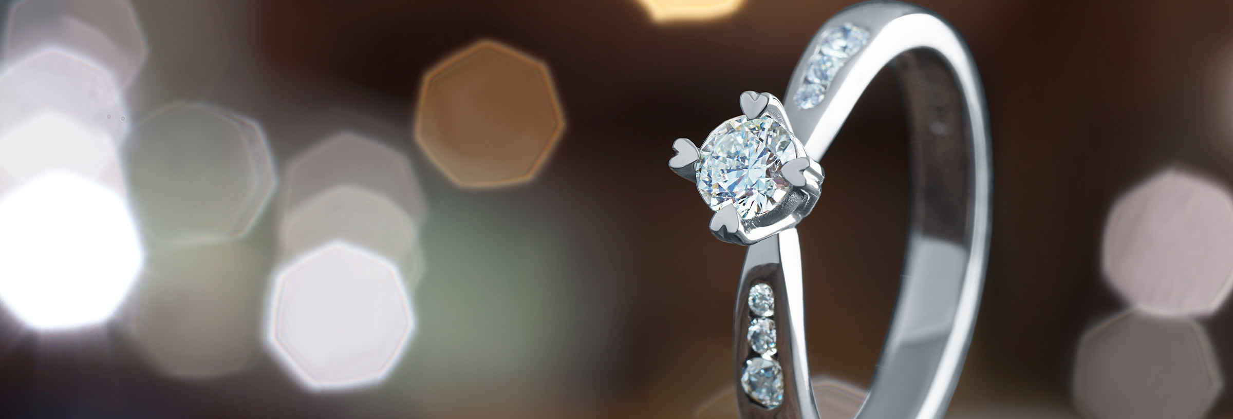 Palladium and diamond engagement ring with heart detailing