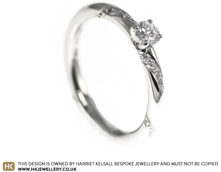 Ribbon style mill grain detailed platinum engagement ring with a 0.24ct H SI1 diamond