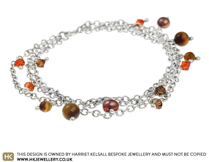 Brown and russet coloured triple chain charm bracelet