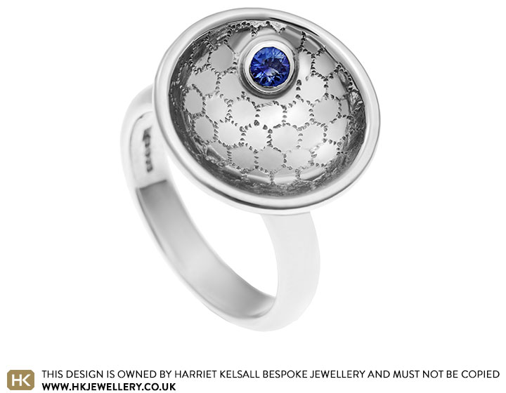 Silver domed and textured ring with a beautiful blue sapphire