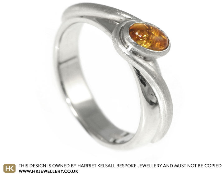 A dramatic amber twist style engagement ring