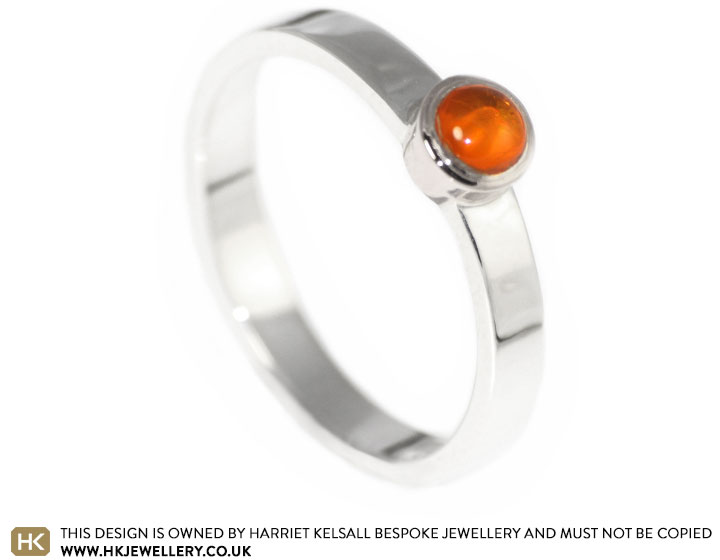 Mixed metal engagement ring with a beautiful crisp orange amber