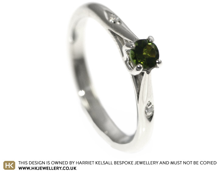 A delicate 9ct white gold and green tourmaline engagement ring