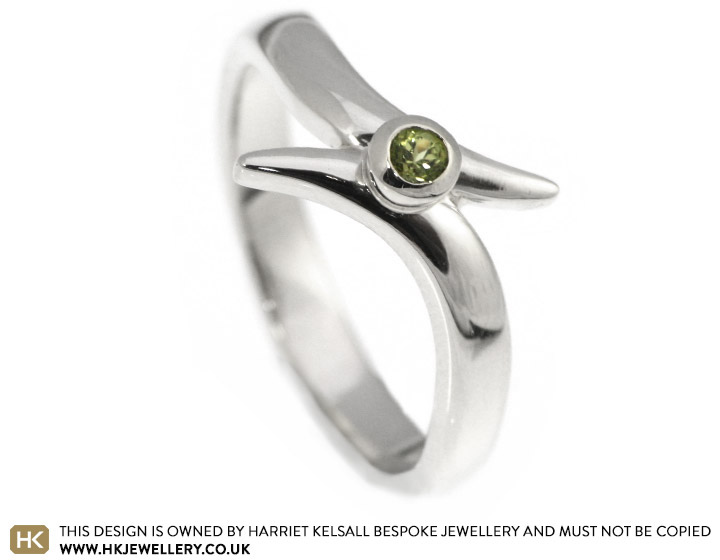 A striking peridot twist style engagement ring