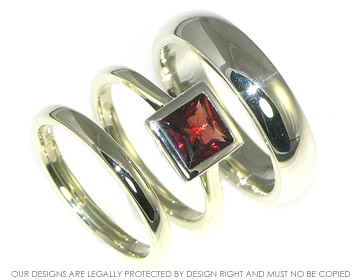 White gold 'open tip' engagement ring with a princess cut garnet 