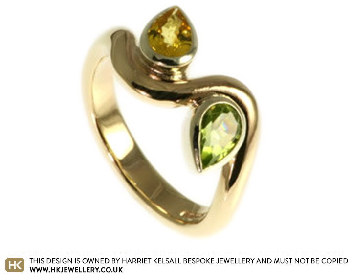 White and yellow gold engagement ring with pear shaped yellow sapphire and a peridot