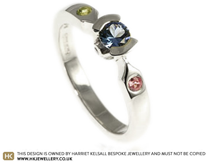 9ct white gold engagement ring with 0.29 cts blue sapphire with 2mm peridot, 2mm sapphire and 1mm diamonds