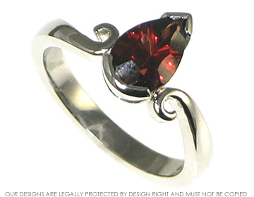 Platinum engagement ring with a 1.42ct pear shape garnet