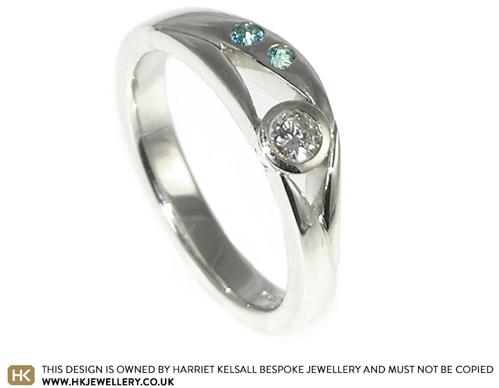 Renee's Diamond Engagement ring with a blue Topaz