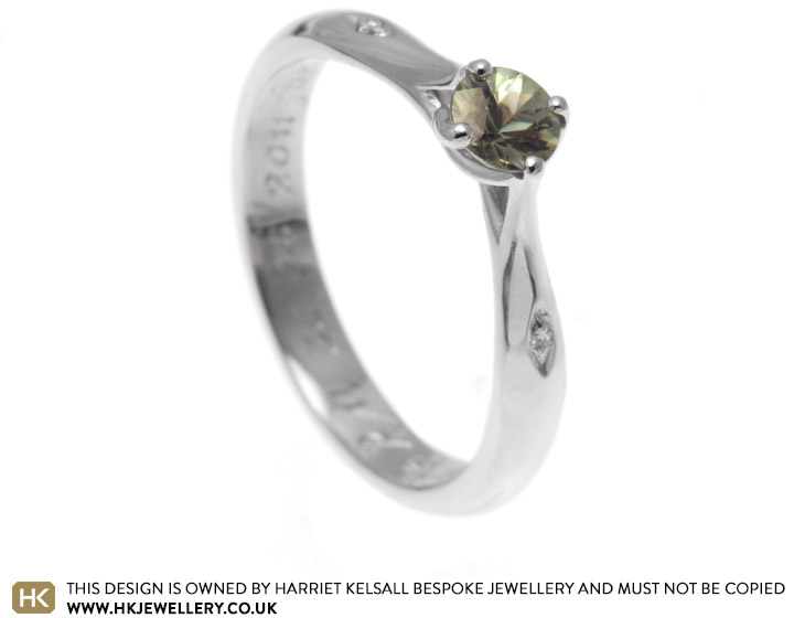 Fairtrade platinum and green sapphire engagement ring with a secret twist