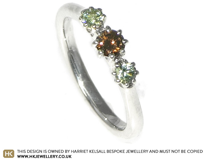 9ct white gold engagement ring with a cognac diamond and pale green sapphires