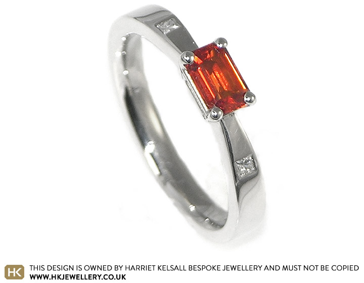 Platinum engagement ring with orange sapphire and diamonds