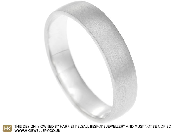 Platinum 4mm wedding band with a flat profile and gentle curve of the outside