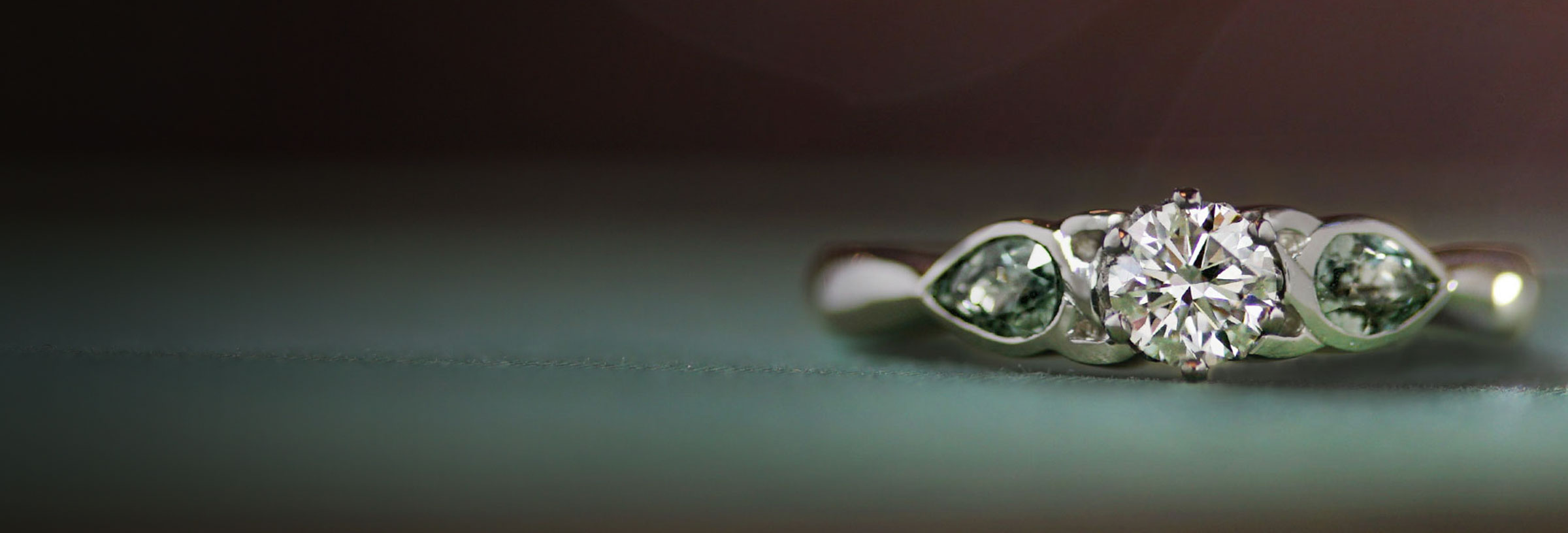 platinum-trilogy-engagement-with-diamond-and-green-sapphires