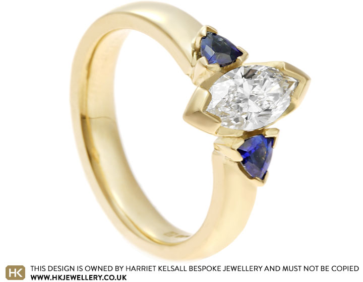 Fairtrade 18 carat yellow gold engagement ring with sapphires and 0.57ct F VS2 marquise cut diamond