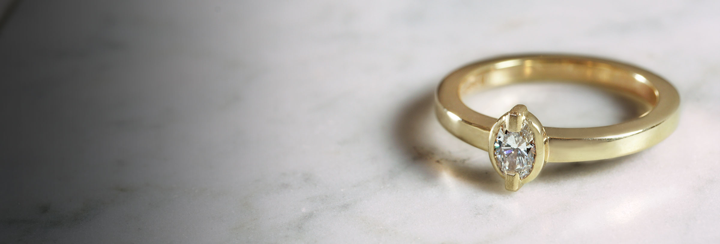 yellow-gold-engagement-ring-with-oval-cut-diamond-and-mixed-finish-detail