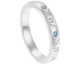 21958-ornate-floral-engraved-platinum-diamond-and-pale-blue-sapphire-eternity-ring_1.jpg