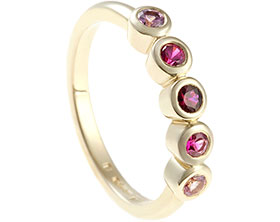 24037-fairtrade-yellow-gold-eternity-ring-with-rubies-and-sapphires_1.jpg