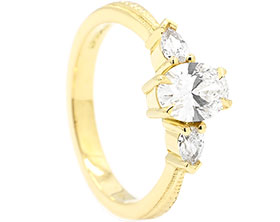 24680-yellow-gold-trilogy-style-engagement-ring-with-pear-cut-diamonds-and-laboratory-grown-oval-cut-diamond_1.jpg