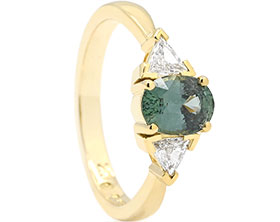 25293-yellow-gold-trilogy-style-engagement-ring-with-trilliant-cut-diamonds-and-teal-sapphire_1.jpg